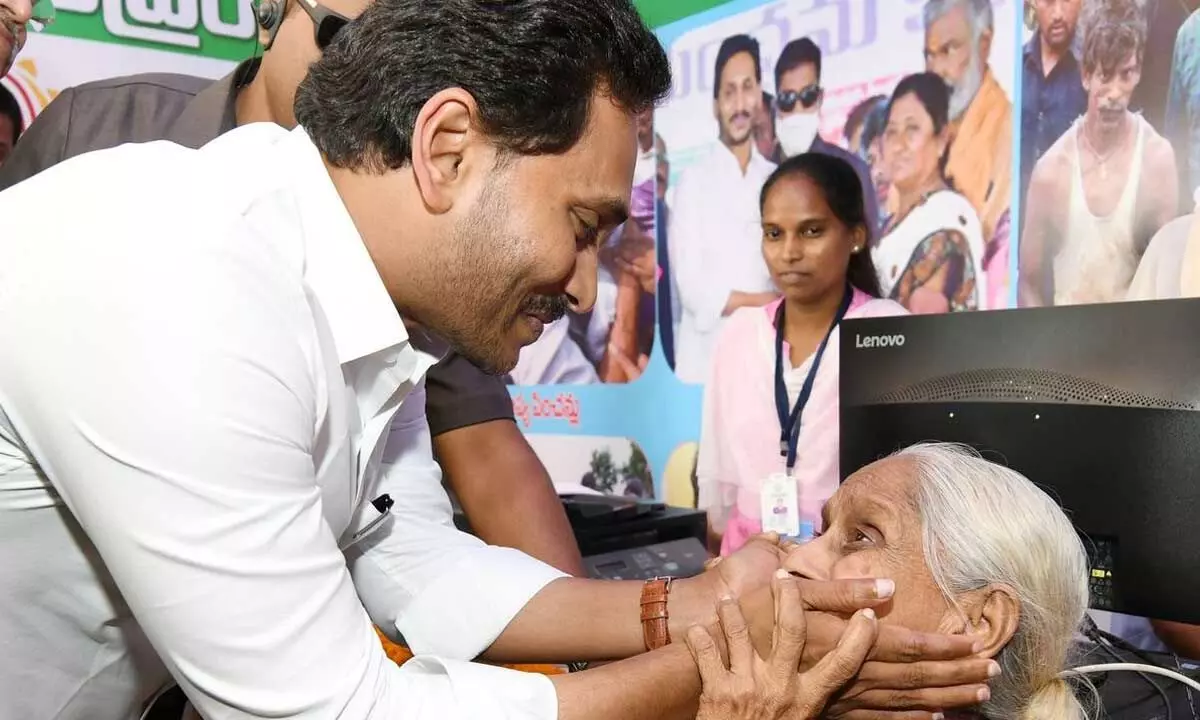 Chief Minister YS Jagan Mohan Reddy interacting with a pensioner during a programme at Rajamahendravaram in East Godavari district on Tuesday