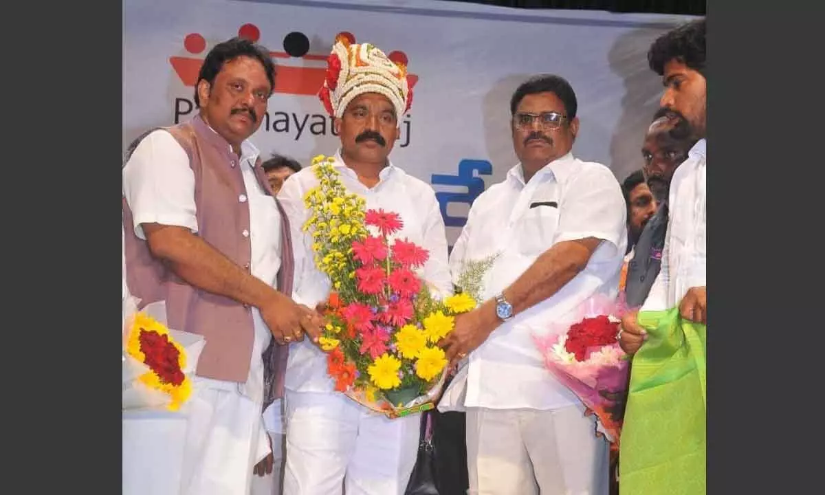 Akhila Bharata Panchayat Parishad national secretary Dr Jasti Veeranjaneyulu felicitating the newly elected president of AP State Sarpanches Welfare Association Chilakalapudi Papa Rao in Vijayawada on Thursday