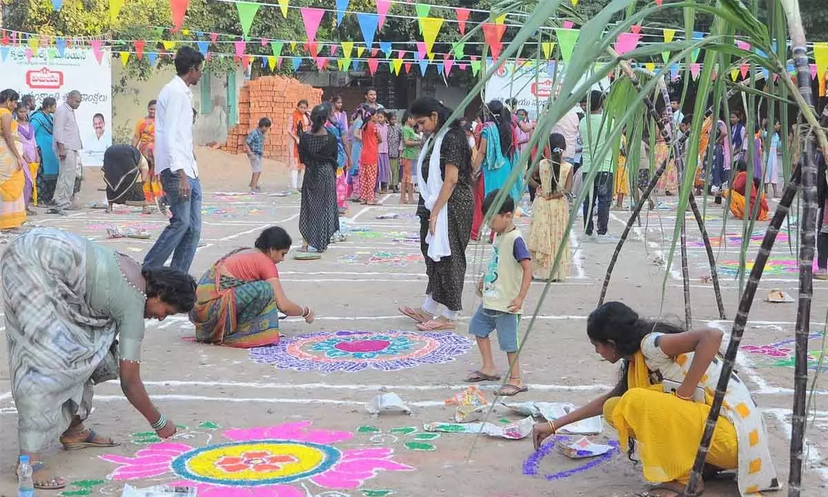 Women participate in Rangoli competitions organised  by hmtv and The Hans India at Care & Share School, New Rajarajeswari Peta, in Vijayawada on Monday  	Hans photo: Ch Venkata Mastan
