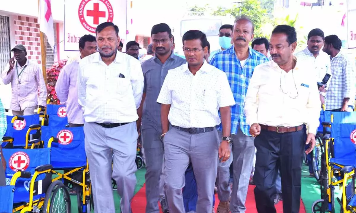 District Collector AS Dinesh Kumar inspecting wheelchairs before distributing them to the beneficiaries at IRCS building in Ongole on Tuesday