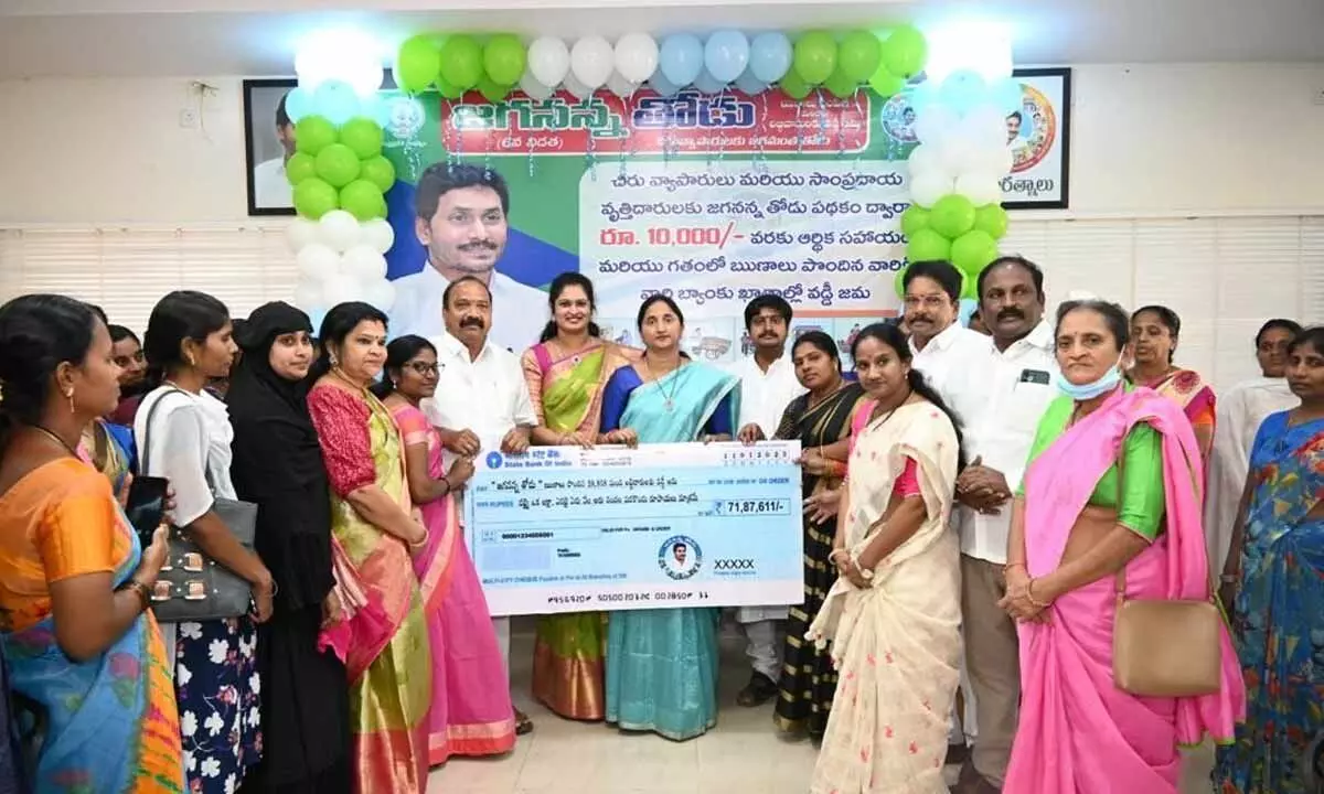 District Collector Dr K Madhavi Latha and others presenting a cheque to beneficiaries of Jagananna Thodu scheme in Rajahmundry on Wednesday