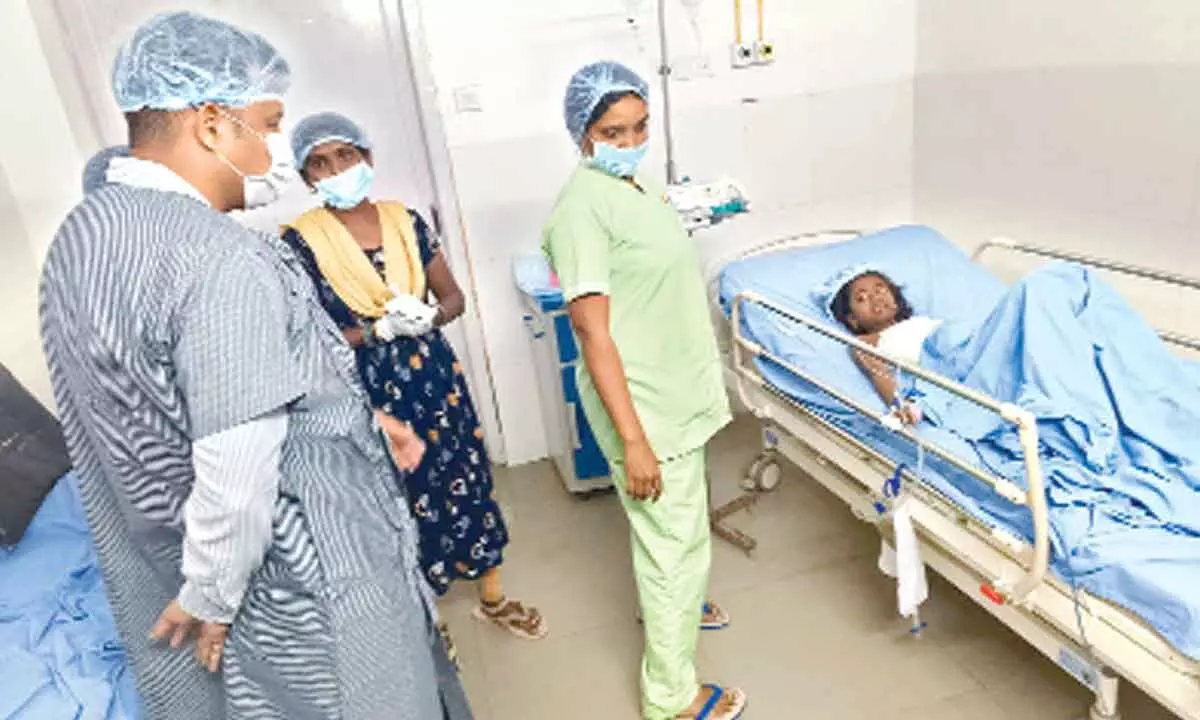 District Collector Himanshu Shukla consoling an injured student at KIMS Hospital in Amalapuram on Thursday