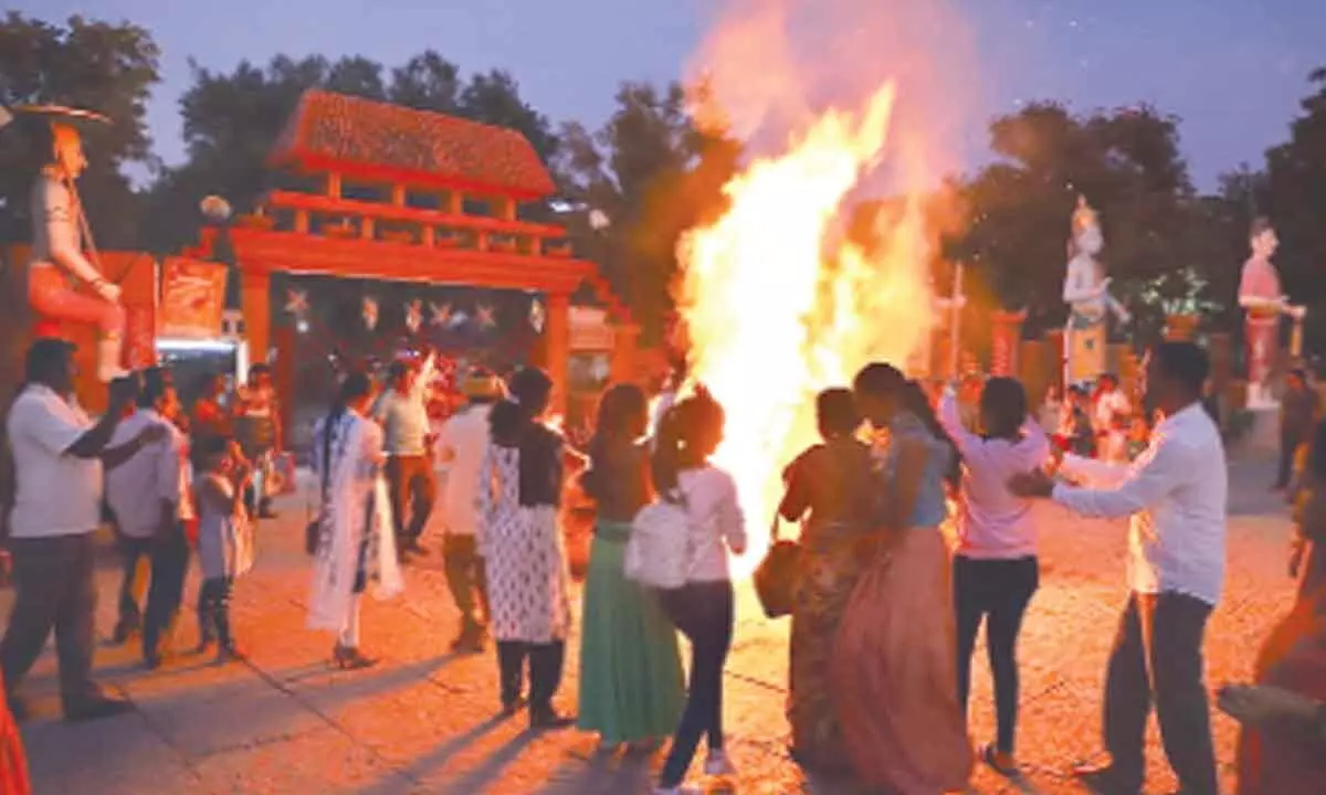 Visitors enjoying Bonfire at Shilparamam in Tirupati on Friday. 	 				Photo: K Radha Krishna