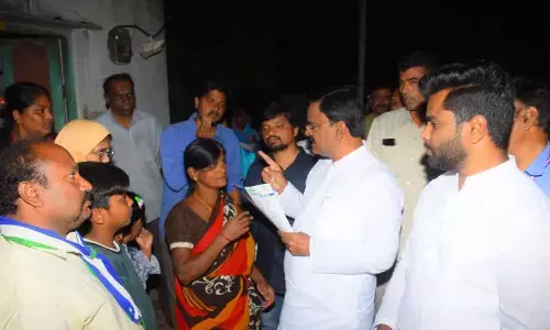 Deputy Chief Minister Amzath Basha interacting with a woman during Gadapa Gadapaku Mana Prabhutvam in Kadapa on Friday
