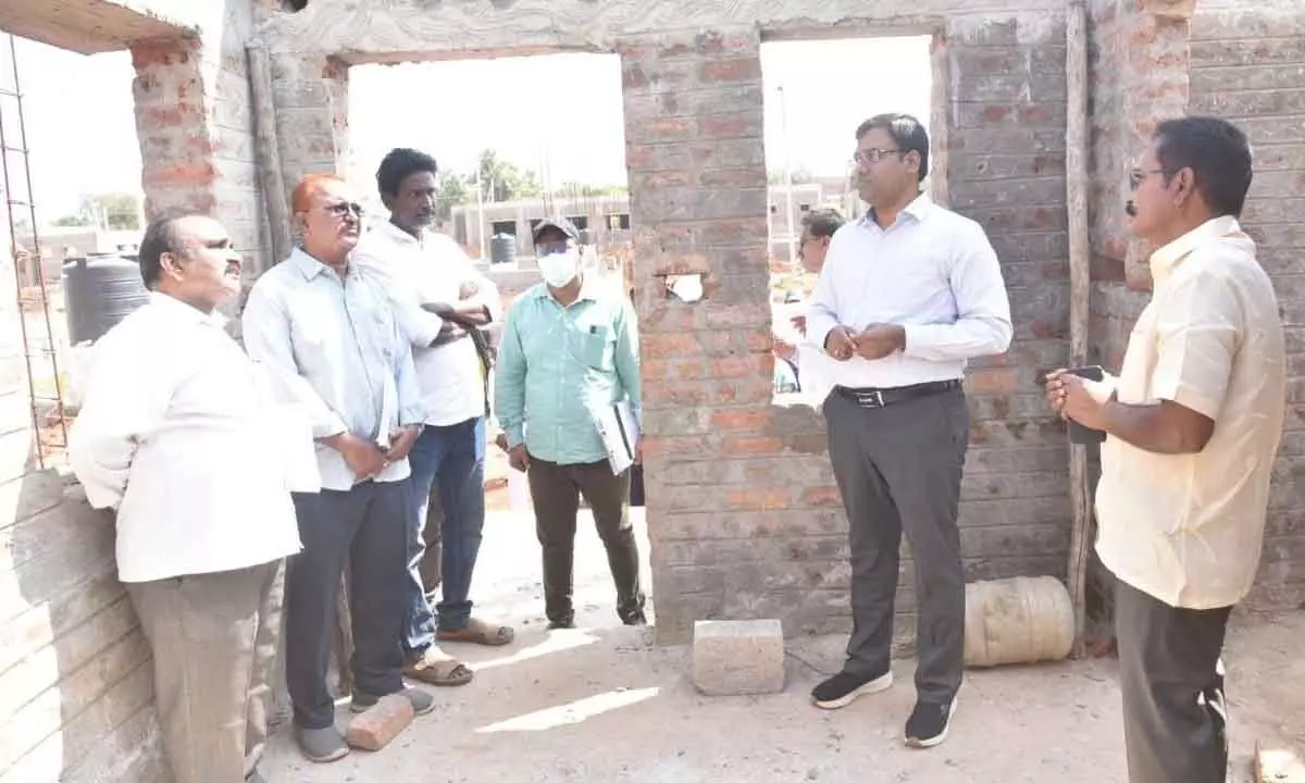 Nellore District Collector KVN Chakradhar Babu interacting with officials on progress of housing in Kattaubadivaripalem in BR Palem mandal on Tuesday