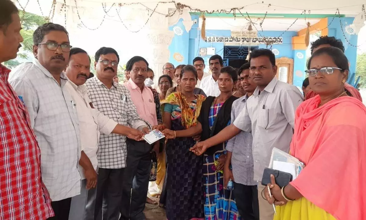 Revenue officials handing over ID cards to Jeelugulova tribals in Anakapalli district on Wednesday
