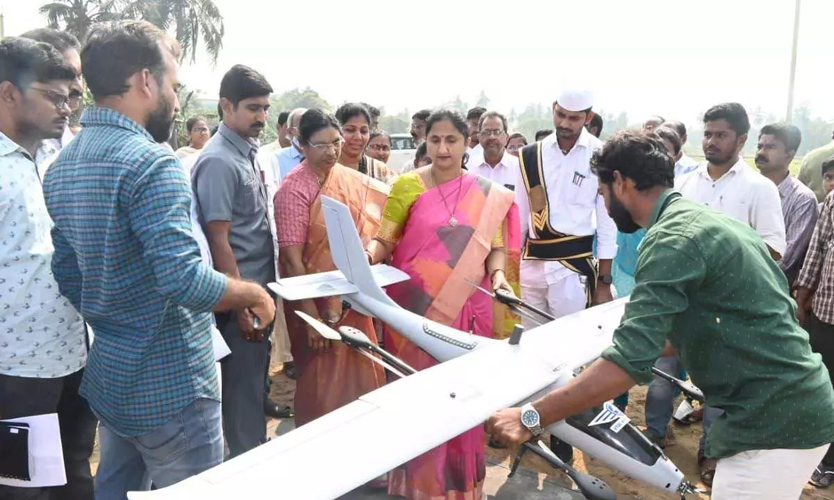 District Collector Dr K Madhavi Latha inspecting a drone that is used for resurvey at Peravali village on Wednesday