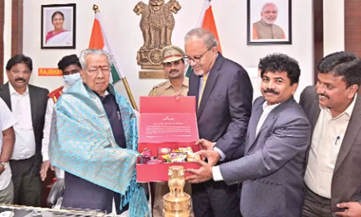 Sri City President (Operations) Satish Kamat presenting a hamper of ‘made at Sri City’ FMCG products to the Governor Biswabhusan Harichandan in Vijayawada on Thursday.