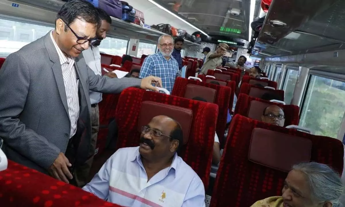 SCR General Manager Arun Kumar Jain interacting with a passenger on Vande Bharat Express on Tuesday