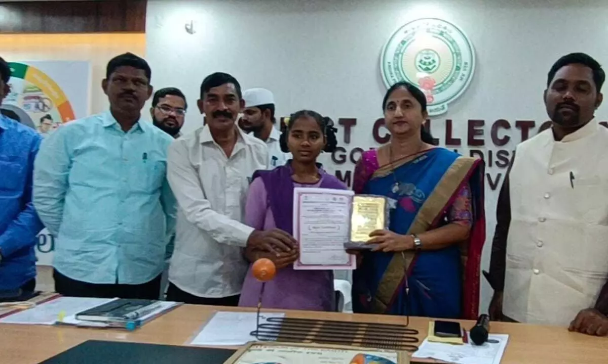 District Collector Dr K Madhavi Latha congratulating Navya Sri for being selected for the National Childrens Science Congress