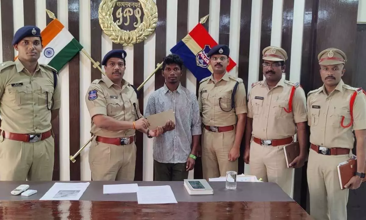 Superintendent of Police Sangramsingh G Patil and other officials with the surrendered Maoist in Mulugu on Wednesday