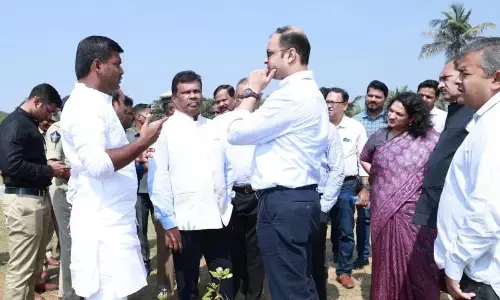 IT Minister Gudivada Amarnath inspecting the arrangements made for the summit at Andhra University Engineering College Grounds, along with district officials on Wednesday