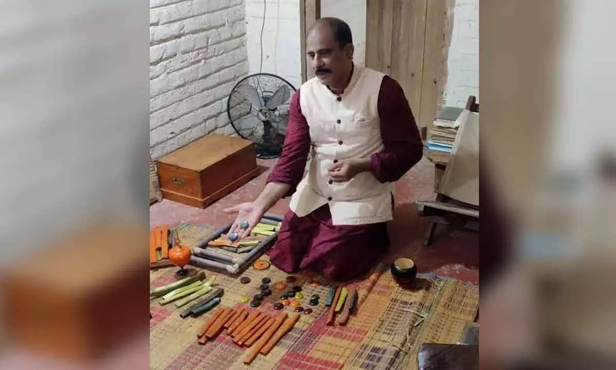 Etikoppaka-based artisan C V Raju explaining the significance of Etikoppaka toys