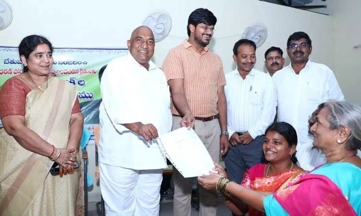 District Collector VP Gautham and Sathupalli MLA Sandra Venkata Veeraiah presenting pattas to farmers which were pending for long time (file photo).
