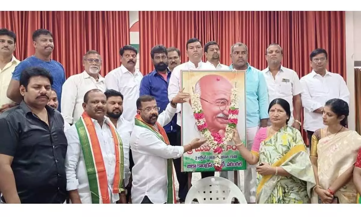 Congress leaders garlanding the portrait of Mahatma Gandhi in Hanumakonda on Monday