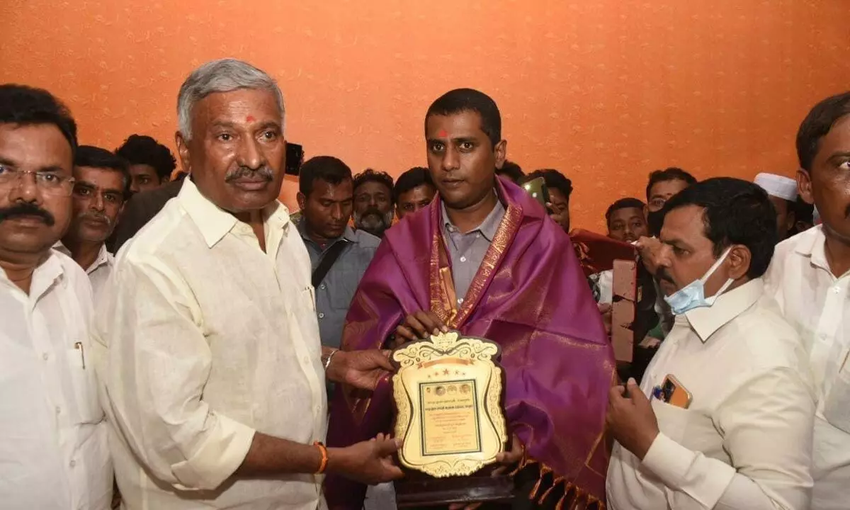 Energy Minister P Ramachandra Reddy felicitating District Collector M Harinarayanan in Punganur on Tuesday