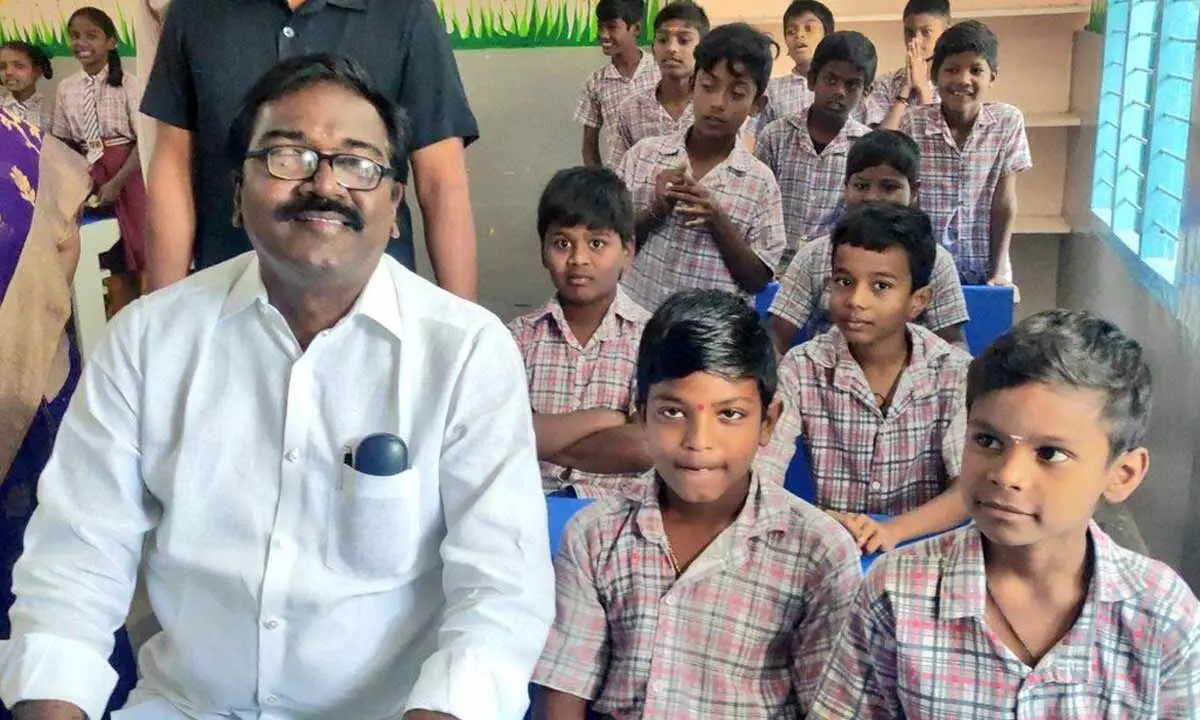 Transport Minister Puvvada Ajay Kumar interacting with students after inaugurating a primary school in Khammam on Wednesday