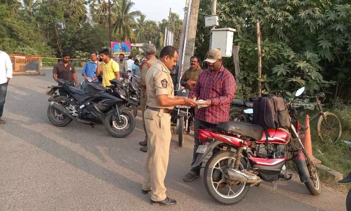 Krishna district police checking vehicles during a special drive in Machilipatnam