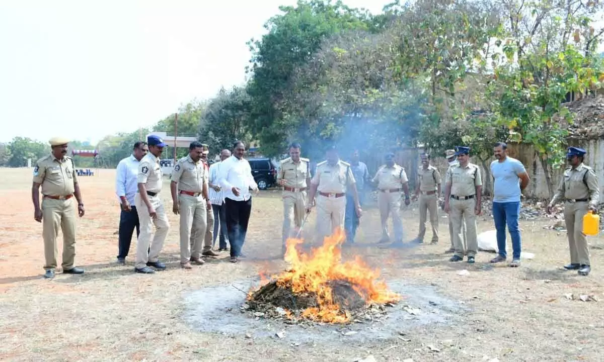 Police burning the seized ganja at the District Police Training Centre at Dinnedevarapadu village in Kurnool on Thursday