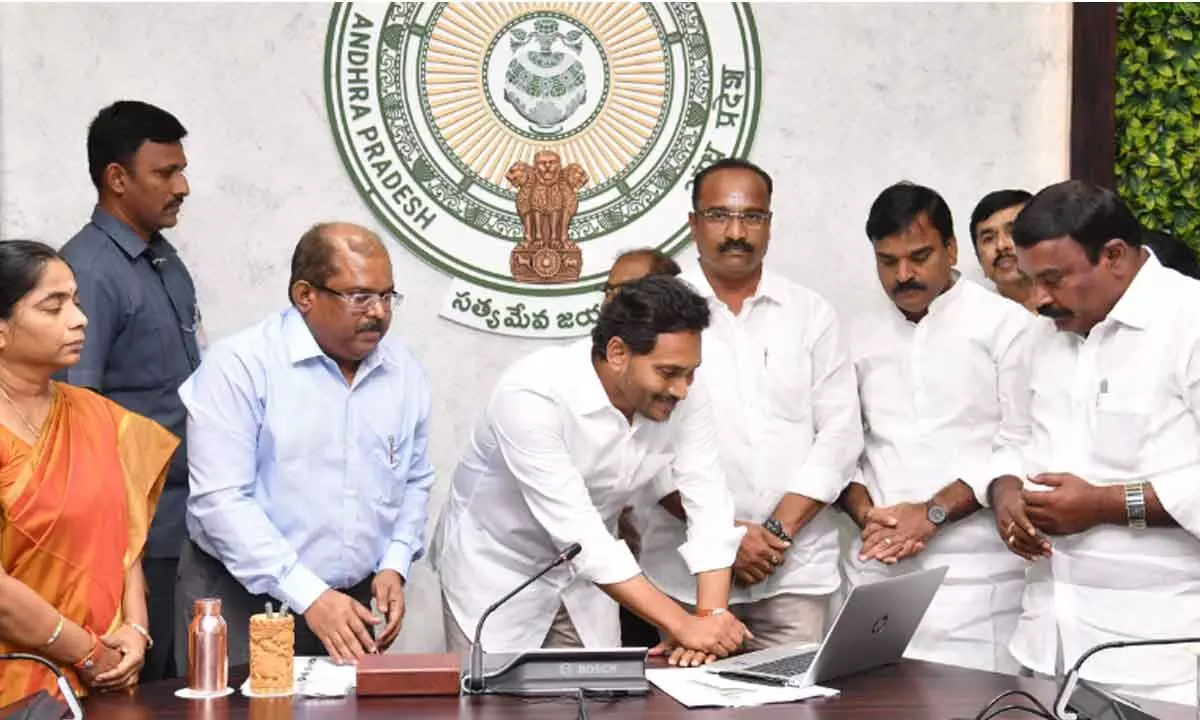 Chief Minister Y S Jagan Mohan Reddy pressing the button to release financial assistance to students under Jagananna Videshi Vidya Deevena at his camp office in Tadepalli on Friday