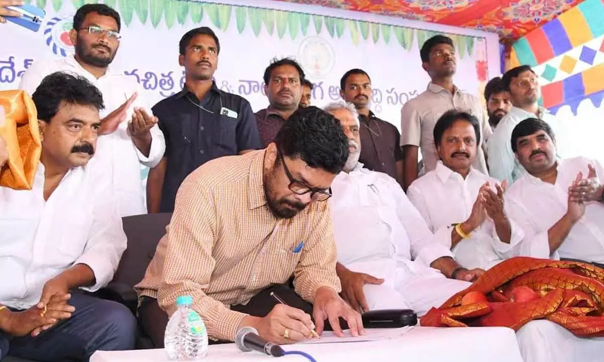 Posani Krishna Murali taking charge as Chairman of Andhra Pradesh State Film Television and Theatre Development Corporation Limited in Vijayawada on Friday. Former Minister Perni Nani (left) and others are seen.      	 Photo: Ch V Mastan