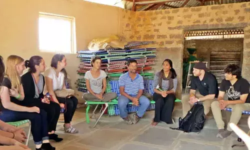 A team of students from New York University on a visit to Proto Village