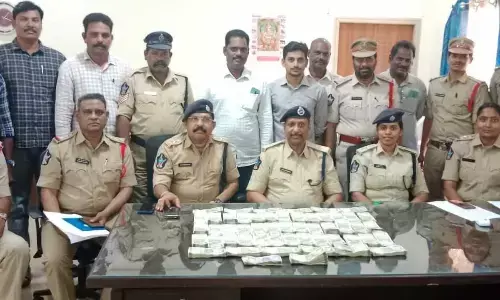 Police officials producing recovered cash before the media in Rajamahendravaram on Tuesday