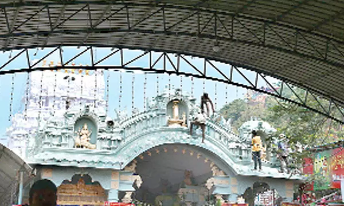 Workers involved in temple illumination at Srikalahasteeswara Swamy Devasthanam ahead of Brahmotsavams