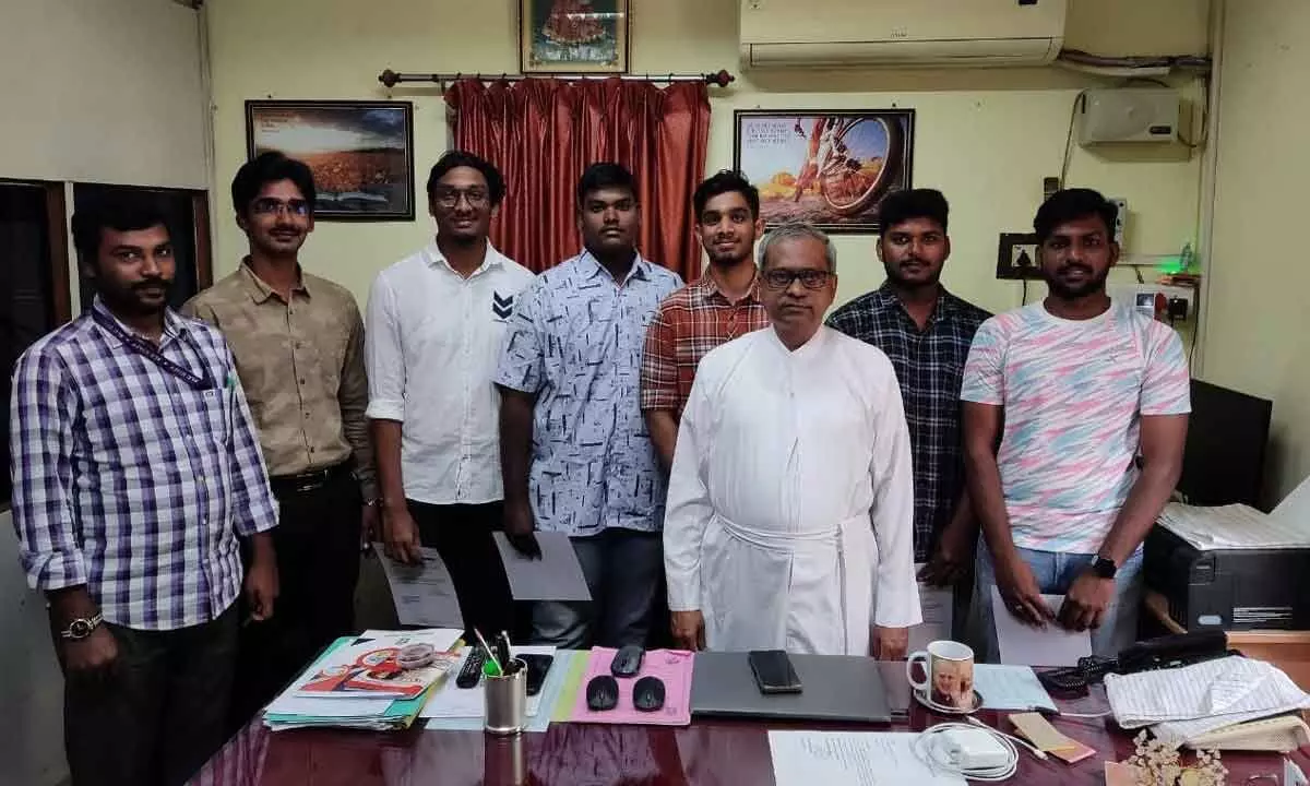 Principal Fr Kishore with students
