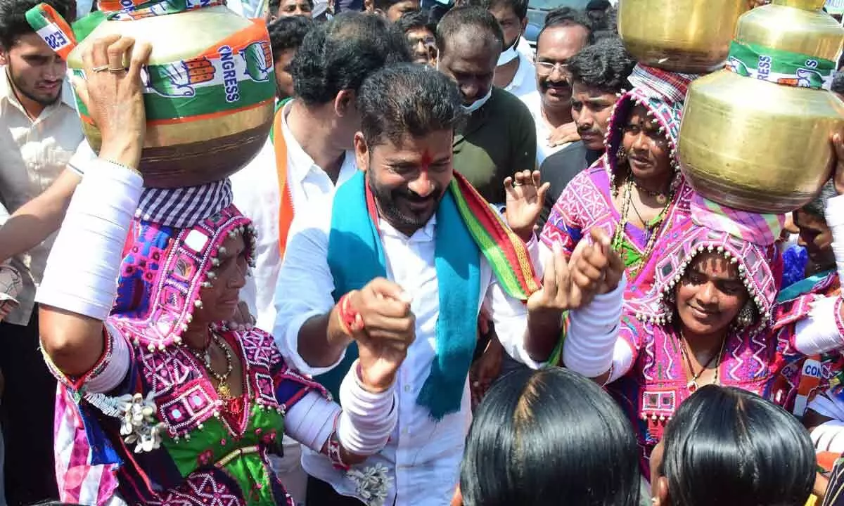 TPCC president A Revanth Reddy dancing with the Lambada women during his Hath Se Hath Jodo Yatra padayatra in Dornakal constituency of Mahabubabad district on Thursday