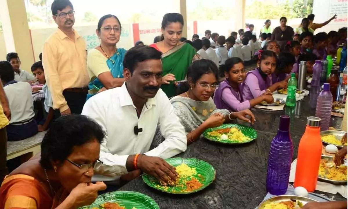 AP State Food Commission member B Kantha Rao along with officials and students having lunch at government high school in Srikakulam city on Thursday