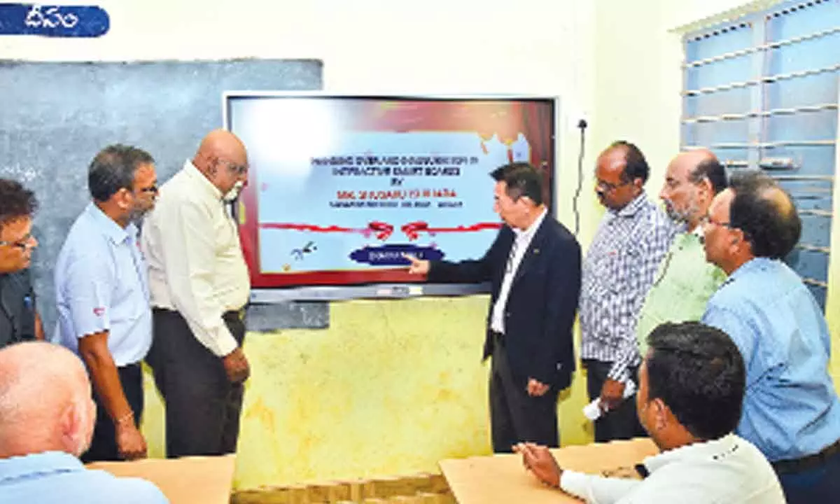 Shusaku Ishihara formally handing over the smart display board to the school headmaster at Madanapalem Zilla Parishad High School in Tirupati on Thursday