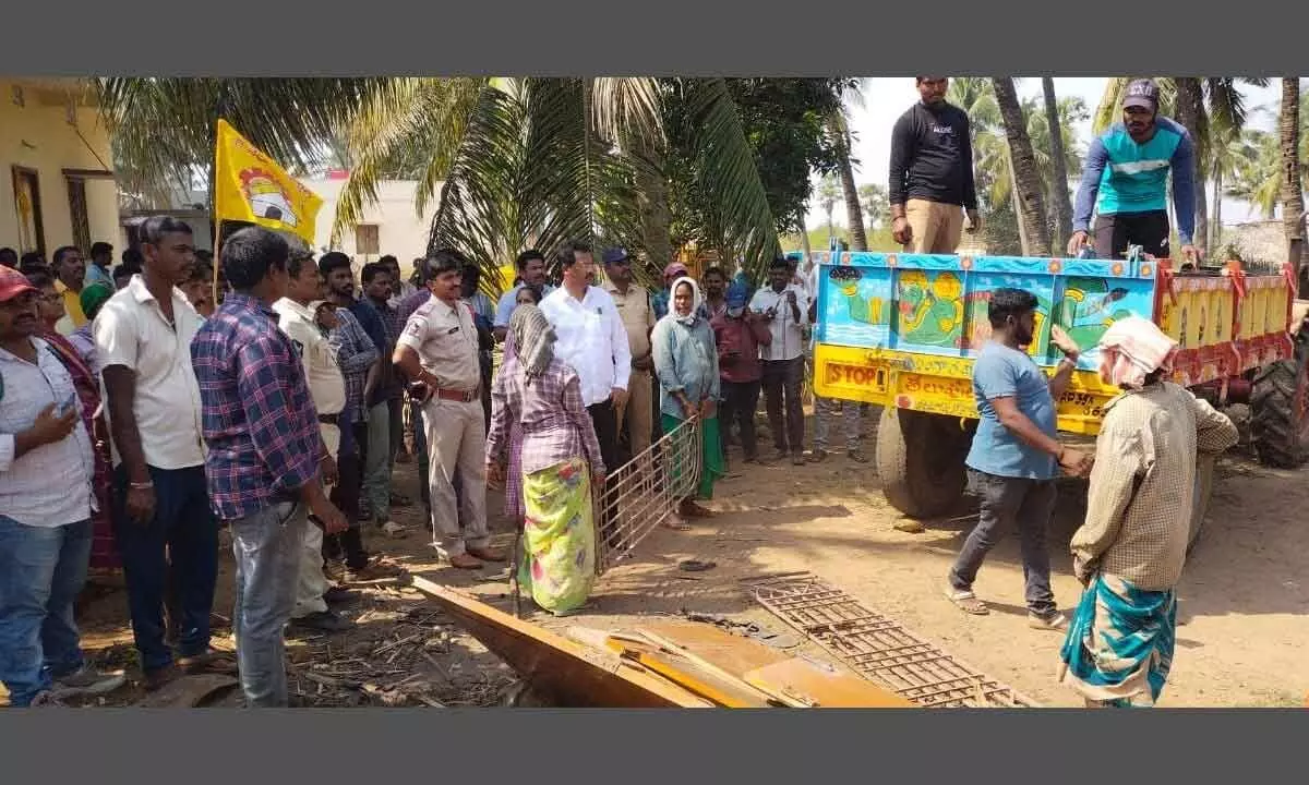 Local people and TDP leaders arguing with revenue and police officials at Maradapalem in Bhogapuram mandal in Vizianagaram district on Friday