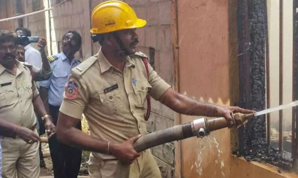 Fire personnel dousing flames at the collectorate in Nellore on Saturday