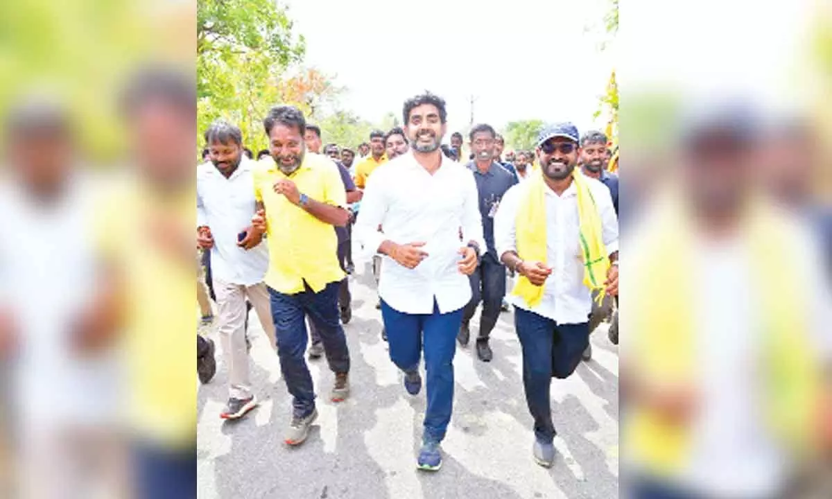 TDP national general secretary Nara Lokesh, former minister N Amaranatha Reddy and others are seen running during the padayatra  in Pillarikuppam of SR Puram mandal in  GD Nellore constituency on Saturday