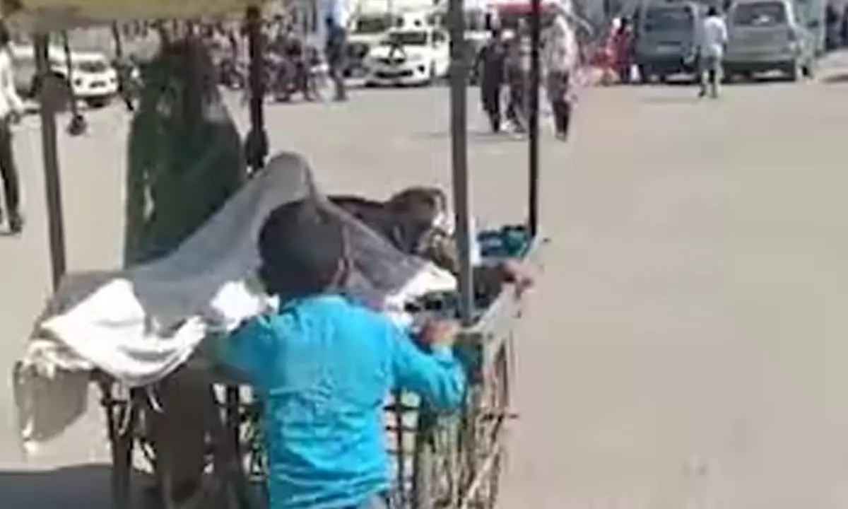 Watch The Trending Video Of A Little Boy Taking Ill Father to Hospital in Wooden Pushcart