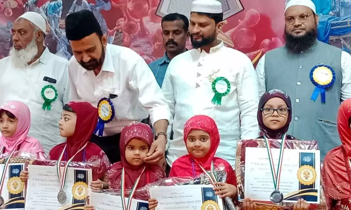 Dignitaries along with the winners of Quranic verses recital competitions in Vijayawada on Sunday