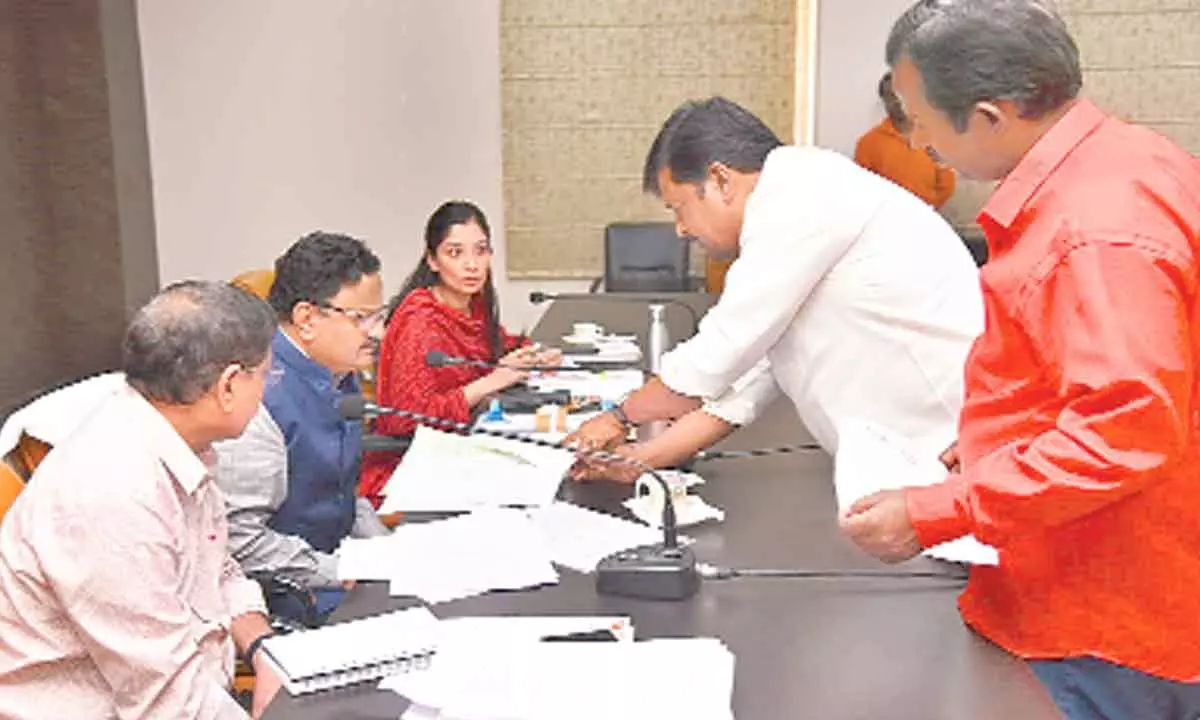 CPM leader Kandharapu Murali submitting a representation  to District Collector  K Venkataramana Reddy on Monday. Commissioner Anupama Anjali, DRO M Srinivasa Rao are also seen