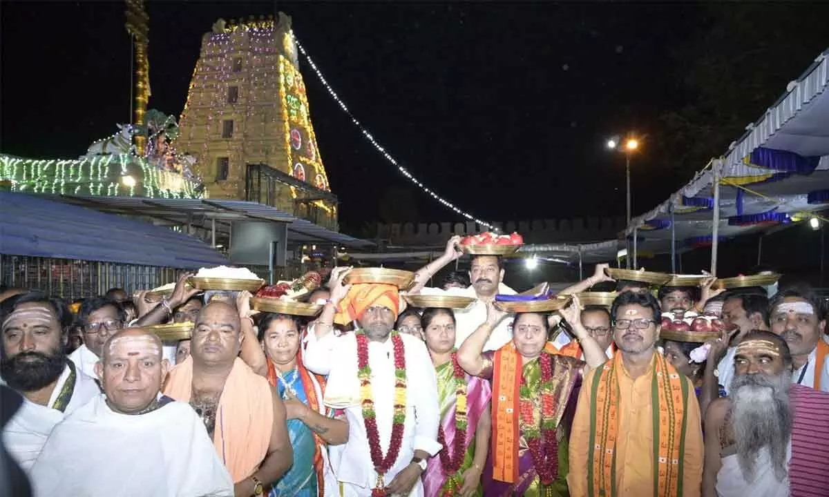 Sri Durga Malleswara Swamy temple chairman K Rambabu, EO D Bhramaramba and others carrying silk clothes to offer them to the presiding deities at Srisailam temple on Monday