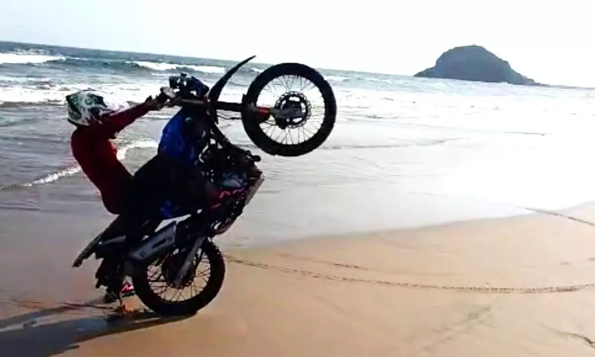 Youth performing stunts at Appikonda beach in Visakhapatnam on Tuesday