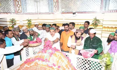 Warangal Urban Co-operative Bank chairman and BJP leader Errabelli Pradeep Rao offering prayers at the Dargah Urus in the presence of Dargah Heads Naveed Baba and Ubed Baba in Warangal on Tuesday