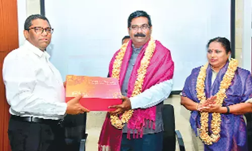 Sri City MD Ravindra Sannareddy presenting a hamper of ‘made @ Sri City’ FMG products to IL Narashima Rao, Senior Manager at Cyber Peace Foundation, Hyderabad. Additional SP Vimala Kumari is also seen.