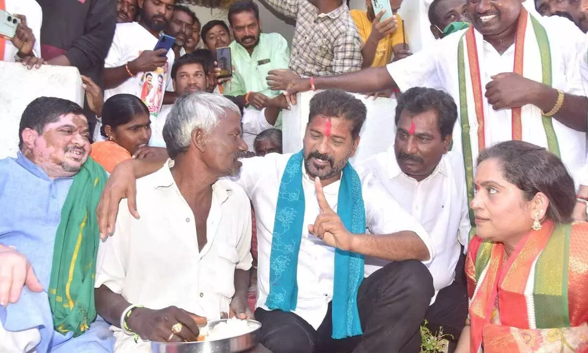 TPCC president A Revanth Reddy speaking to a farmer during his Hath Se Hath Jodo yatra in Palakurthi constituency on Wednesday