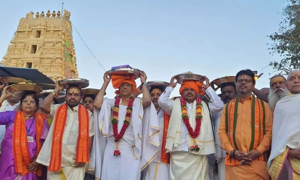 Finance Minister Buggana Rajendranath Reddy carrying the silk robes on his head to present to Lord Mallikarjuna Swamy and Goddess Bramarambika Devi on behalf of state government in Srisailam on Wednesday.