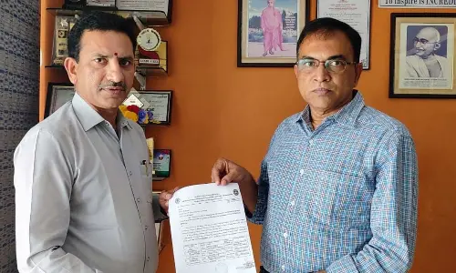 Dr D V V Rama Reddy handing over letter of appointment as contingency in-charge National Integration Camp to Dr T Haribabu