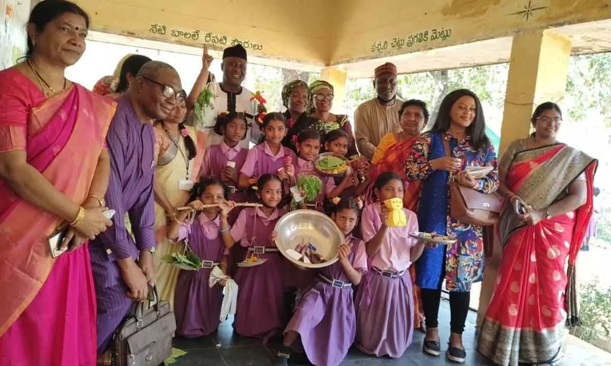 The Nigerian team with the students of Mandal Parishad Primary School at Venkatapuram near Vijayawada on Thursday