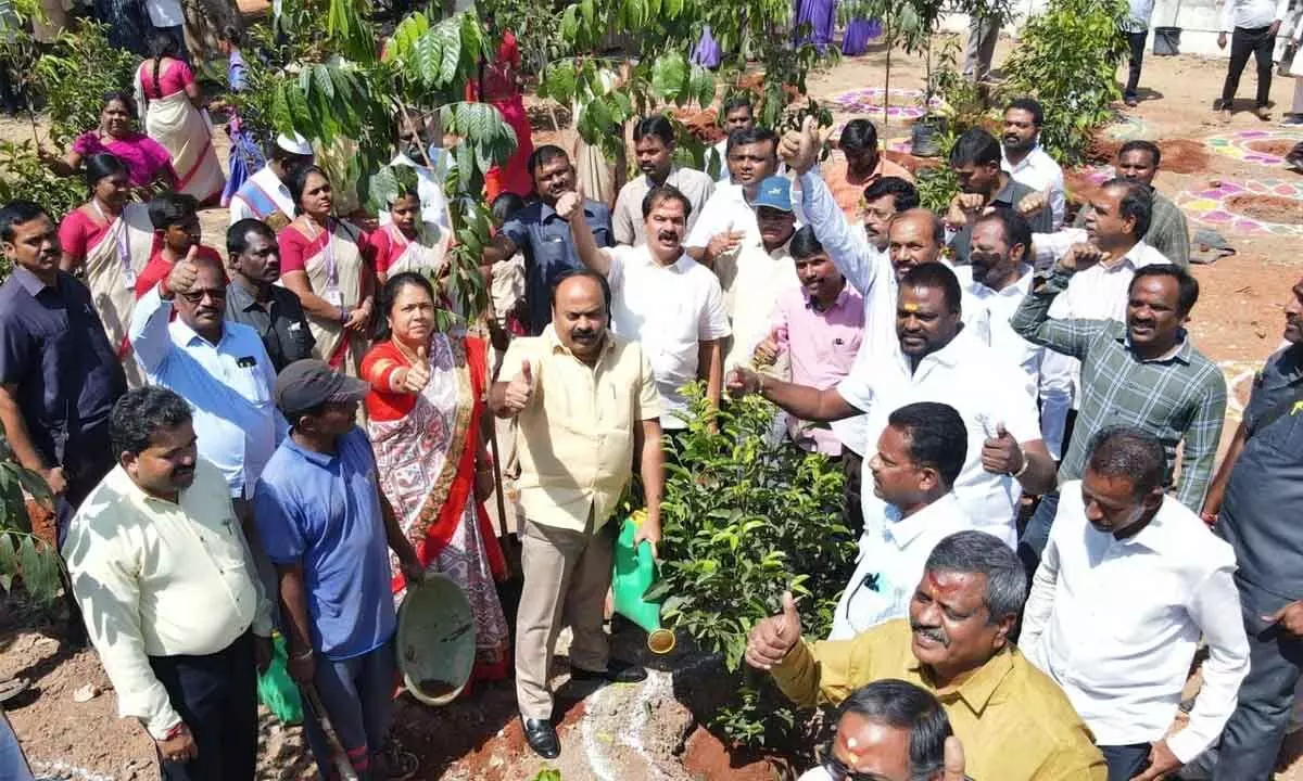 Chief Whip D Vinay Bhaskar and Mayor Gundu Sudharani cheer after planting saplings as part of KCRs birthday celebration in Hanumakonda on Friday