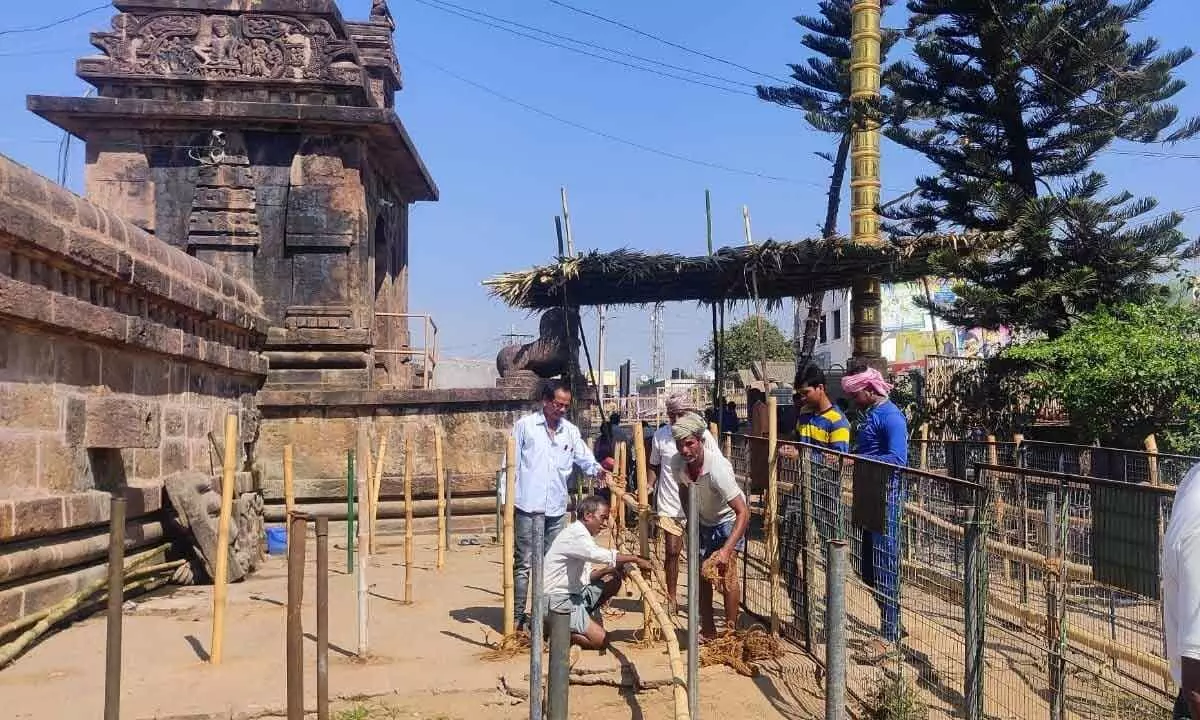 Workers erecting queue lines on the temple premises