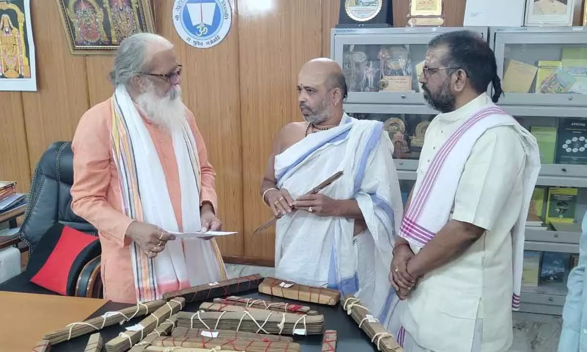 Hyderabad-based Vedic scholar Agnihotri Brahmasri Dendukuri Venkata Satyanarayna Sarma donats rare palm leaf manuscripts to Vedic University vice-chancellor Rani Sadasiva Murthy on Friday