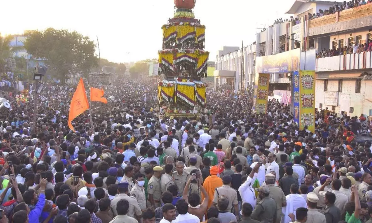 Scores of devotees participating in the Rathotsavam being taken out on the temple streets in Srisailam on Sunday